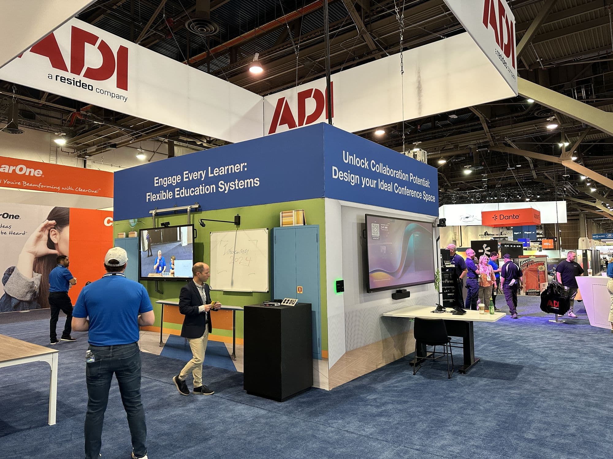 An education demo classroom and a conference room demo, side by side in a trade show booth