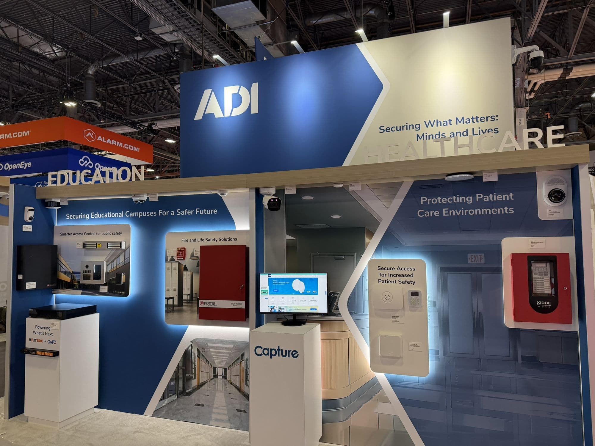Healthcare and education demonstration zones with displays and security devices in a trade show booth