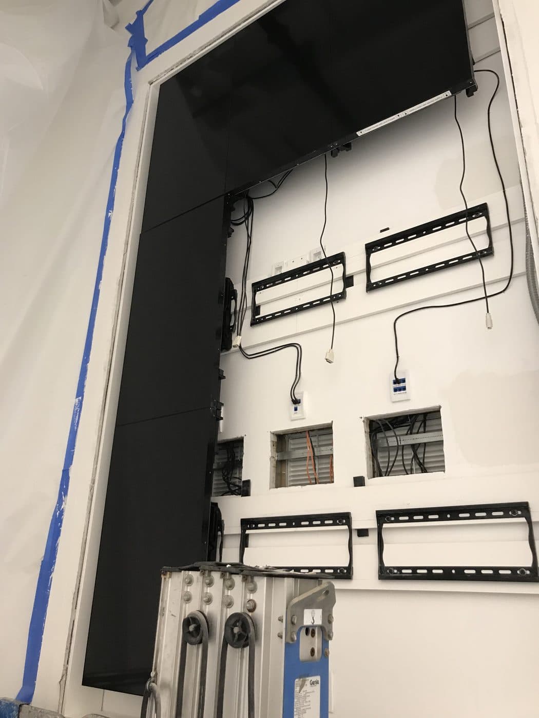 The video wall going up: mounting brackets on the wall and the first displays in place