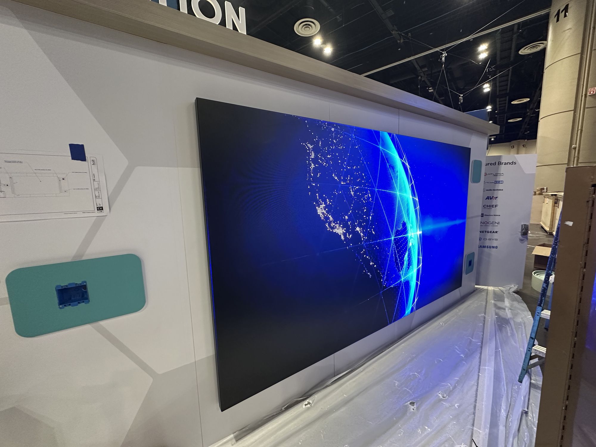 The same LED video wall lit and tested, with protective sheeting still on the floor